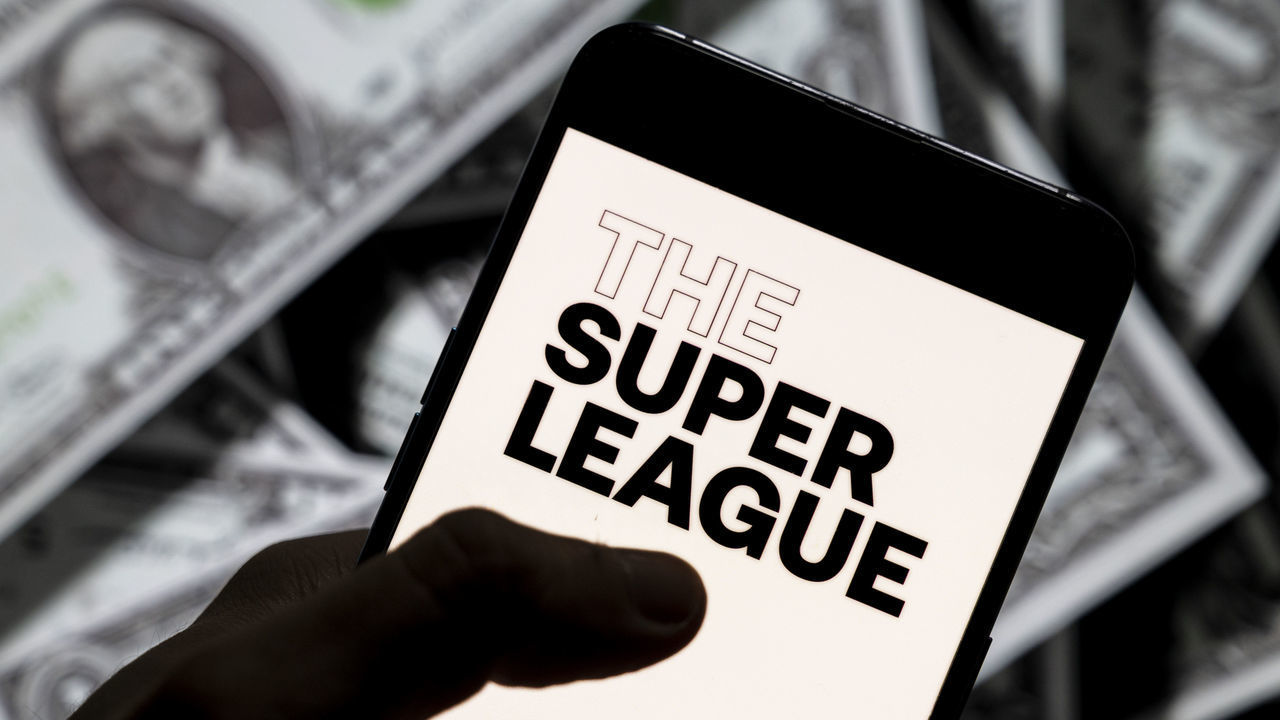 CHINA - 2021/04/23: In this photo illustration, The Super League logo seen displayed on a smartphone with USD (United States dollar) currency in the background. (Photo Illustration by Budrul Chukrut/SOPA Images/LightRocket via Getty Images)