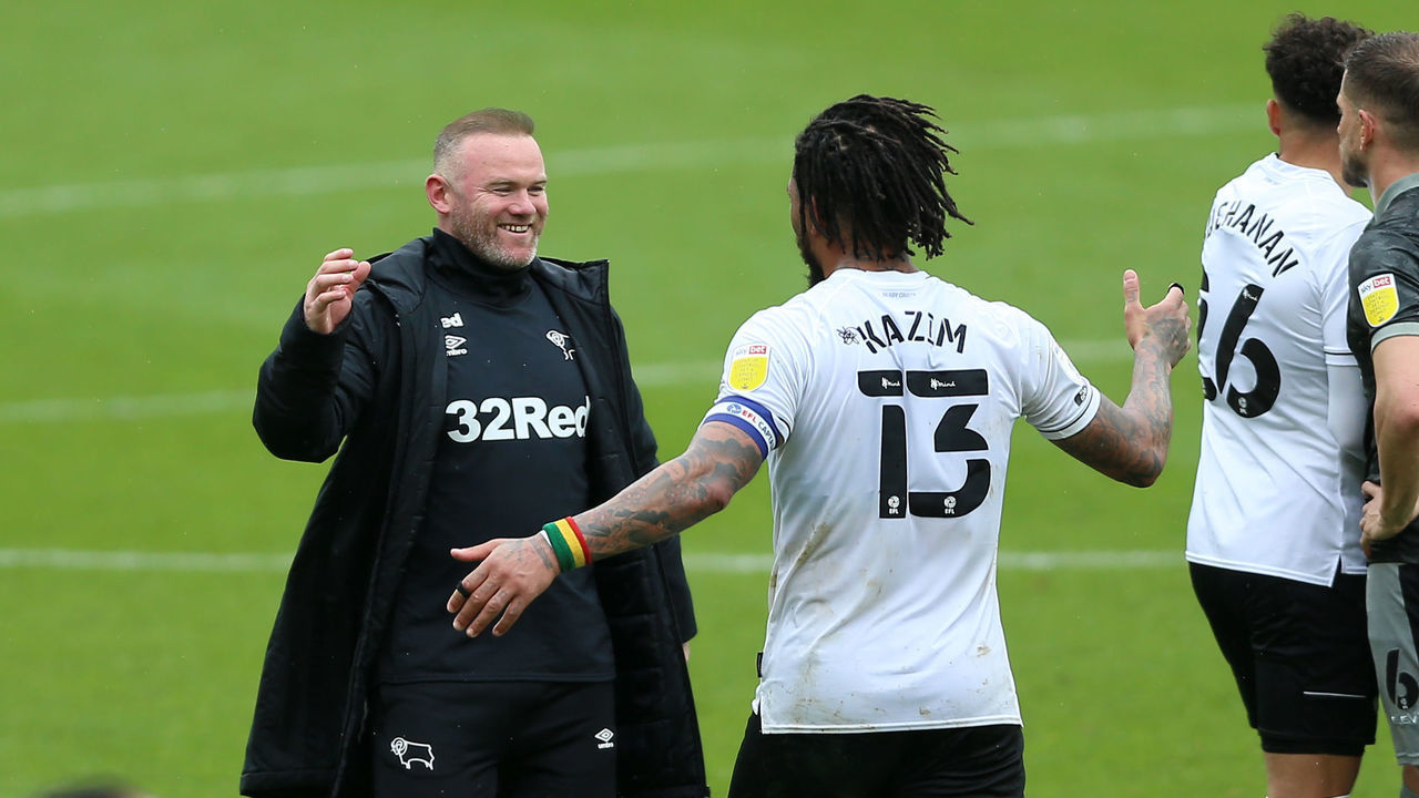 Derby County manager Wayne Rooney (left) celebrates with Colin Kazim-Richards (13) after the Sky Bet Championship match at Pride Park, Derby. Picture date: Saturday May 8, 2021.