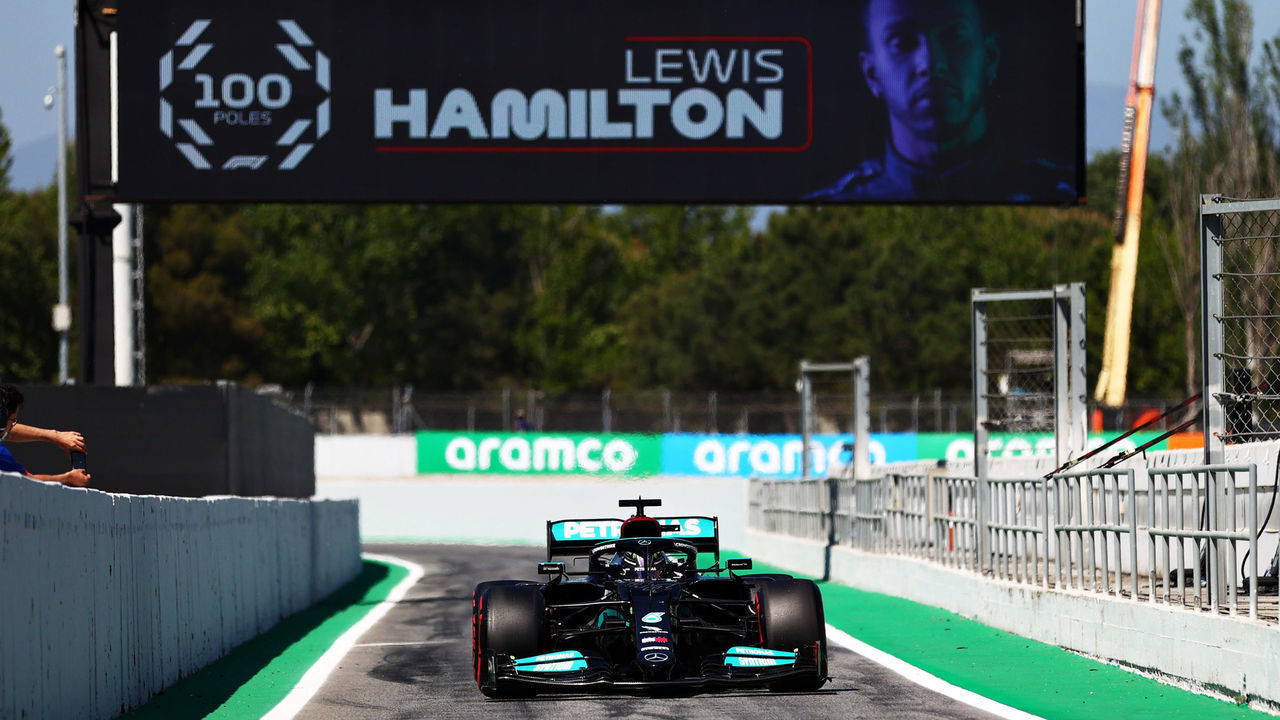 BARCELONA, SPAIN - MAY 08: Pole position qualifier Lewis Hamilton of Great Britain and Mercedes GP pulls into parc ferme under a banner celebrating his 100 pole positions during qualifying for the F1 Grand Prix of Spain at Circuit de Barcelona-Catalunya on May 08, 2021 in Barcelona, Spain.