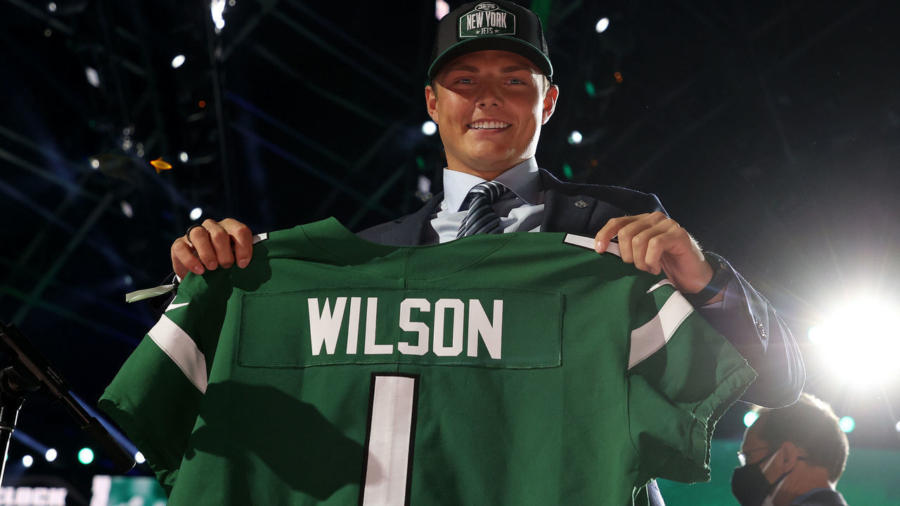 CLEVELAND, OHIO - APRIL 29: Zach Wilson holds a jersey onstage after being drafted second by the New York Jets during round one of the 2021 NFL Draft at the Great Lakes Science Center on April 29, 2021 in Cleveland, Ohio.