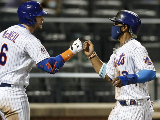 NEW YORK, NEW YORK - APRIL 14: (NEW YORK DAILIES OUT) Francisco Lindor #12 and Jeff McNeil #6 of the New York Mets in action against the Philadelphia Phillies at Citi Field on April 14, 2021 in New York City. The Mets defeated the Phillies 5-1.