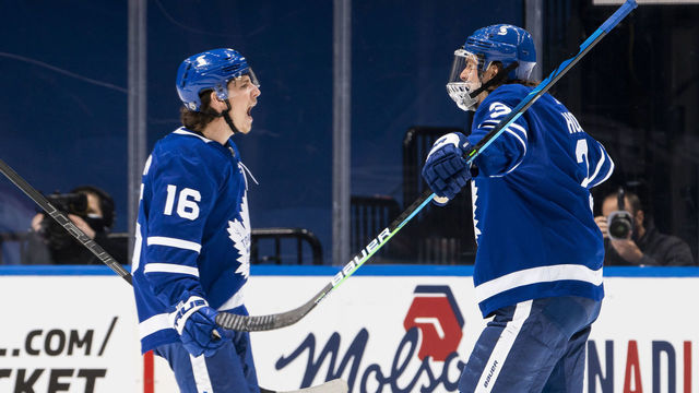 TORONTO, ON - MAY 8: Mitchell Marner #16 of the Toronto Maple Leafs celebrates his goal against the Montreal Canadiens with teammate Justin Holl #3 during the second period at the Scotiabank Arena on May 8, 2021 in Toronto, Ontario, Canada.