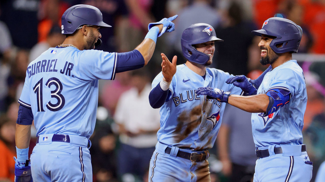 HOUSTON, TEXAS - MAY 08: Marcus Semien #10 of the Toronto Blue Jays celebrates with Lourdes Gurriel Jr. #13 and Cavan Biggio #8 of the Toronto Blue Jays after hitting a three run home run during the ninth inning against the Houston Astros at Minute Maid Park on May 08, 2021 in Houston, Texas.