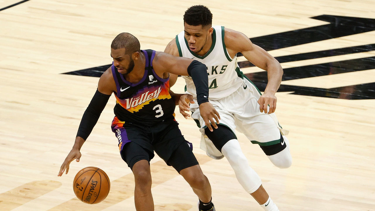PHOENIX, ARIZONA - FEBRUARY 10: Chris Paul #3 of the Phoenix Suns handle the ball against Giannis Antetokounmpo #34 of the Milwaukee Bucks during the second half of the NBA game at Phoenix Suns Arena on February 10, 2021 in Phoenix, Arizona. The Suns defeated the Bucks 125-124.