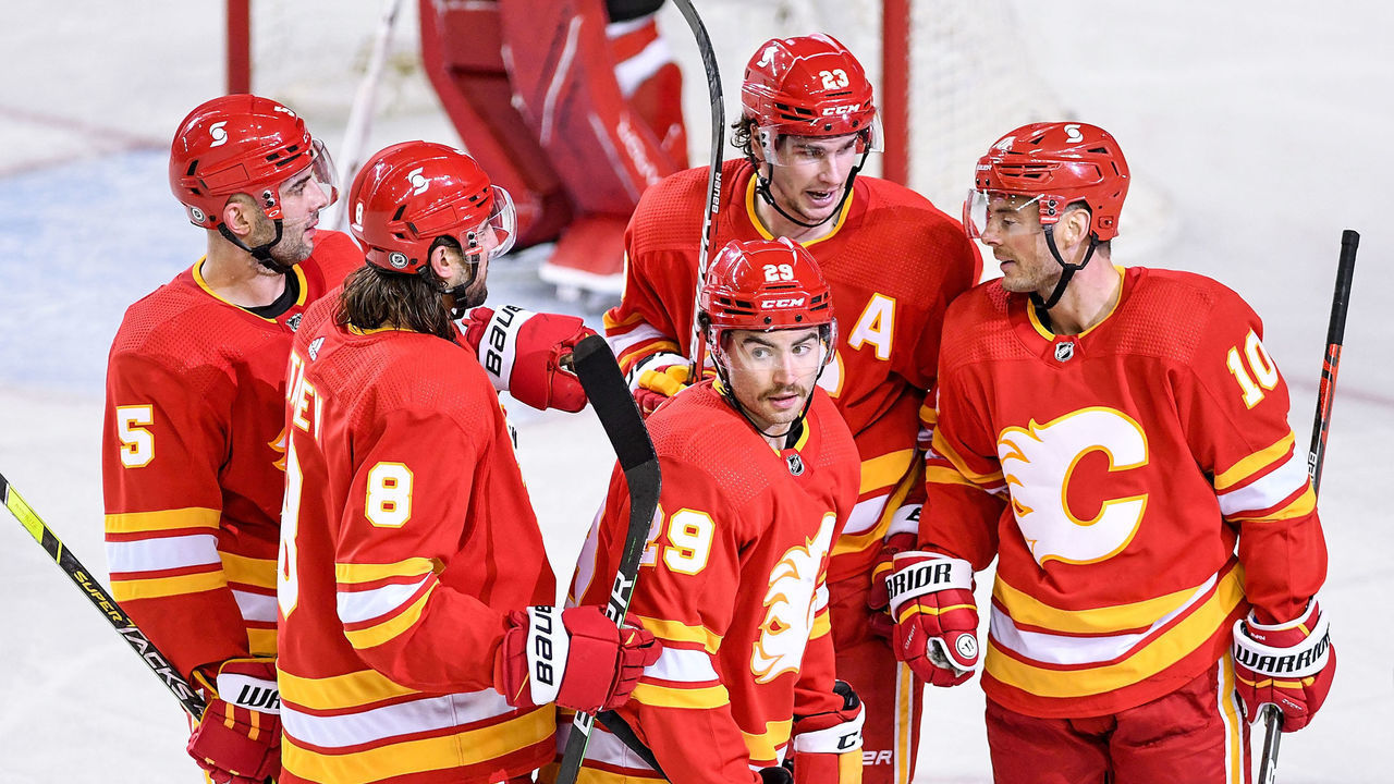 CALGARY, AB - MAY 09: Calgary Flames Winger Dillon Dube (29) celebrates a goal with Calgary Flames Defenceman Mark Giordano (5), Calgary Flames Defenceman Christopher Tanev (8), Calgary Flames Center Sean Monahan (23) and Calgary Flames Right Wing Derek Ryan (10) during the third period of an NHL game where the Calgary Flames hosted the Ottawa Senators on May 9, 2021, at the Scotiabank Saddledome in Calgary, AB.