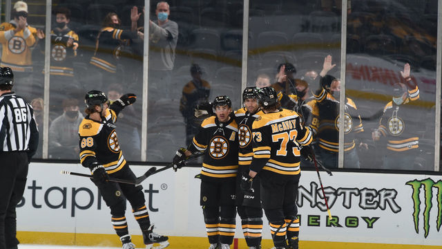 BOSTON, MA - MAY 6: Patrice Bergeron #37 of the Boston Bruins hugs his line-mates after scoring a goal in the first period against the New York Rangers at the TD Garden on May 6, 2021 in Boston, Massachusetts.