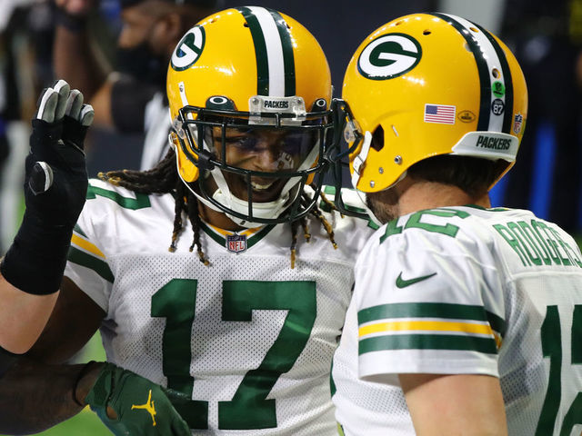DETROIT, MICHIGAN - DECEMBER 13: Aaron Rodgers #12 of the Green Bay Packers celebrates rushing for a touchdown with Davante Adams #17 of the Green Bay Packers during the third quarter against the Detroit Lions at Ford Field on December 13, 2020 in Detroit, Michigan.