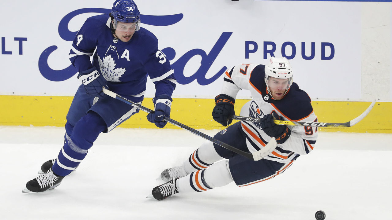 TORONTO, ON - March 29 In first period action, Toronto Maple Leafs center Auston Matthews (34) and Edmonton Oilers center Connor McDavid (97) chase the puck in the Leafs end. The Toronto Maple Leafs took on the Edmonton Oilers in NHL hockey action at the Scotiabank Arena in Toronto. March 29 2021 (Richard Lautens/Toronto Star via Getty Images)