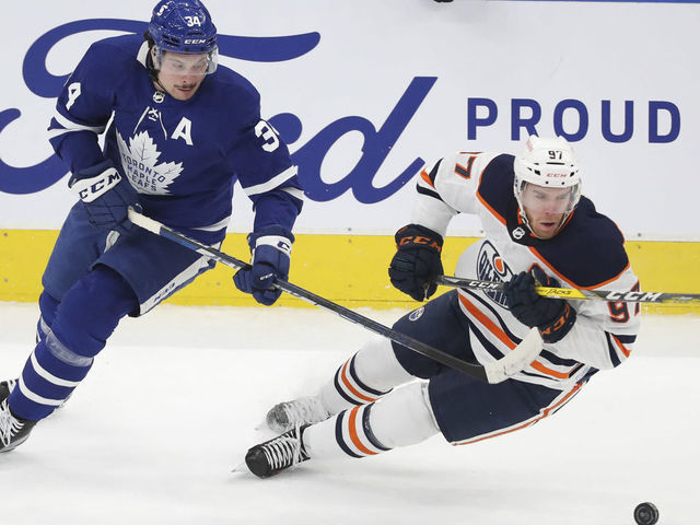 TORONTO, ON - March 29 In first period action, Toronto Maple Leafs center Auston Matthews (34) and Edmonton Oilers center Connor McDavid (97) chase the puck in the Leafs end. The Toronto Maple Leafs took on the Edmonton Oilers in NHL hockey action at the Scotiabank Arena in Toronto. March 29 2021 (Richard Lautens/Toronto Star via Getty Images)