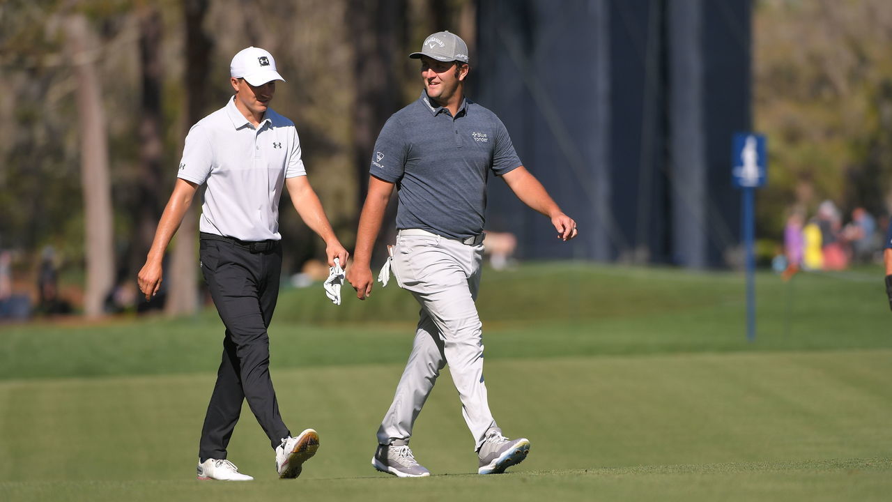 PONTE VEDRA BEACH, FL - MARCH 11: Jordan Spieth and Jon Rahm walk down the 11th fairway during the first round of THE PLAYERS Championship on THE PLAYERS Stadium Course at TPC Sawgrass on March 11, 2021, in Ponte Vedra Beach, FL.