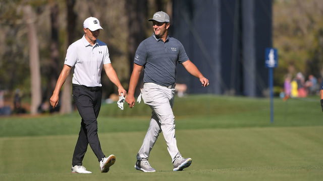 PONTE VEDRA BEACH, FL - MARCH 11: Jordan Spieth and Jon Rahm walk down the 11th fairway during the first round of THE PLAYERS Championship on THE PLAYERS Stadium Course at TPC Sawgrass on March 11, 2021, in Ponte Vedra Beach, FL.