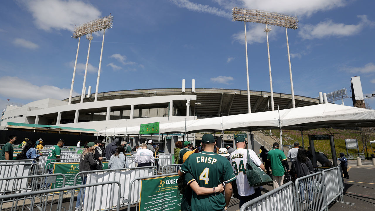 OAKLAND, CALIFORNIA - APRIL 03: Fans enter the stadium for the Oakland Athletics game against the Houston Astros at RingCentral Coliseum on April 03, 2021 in Oakland, California.