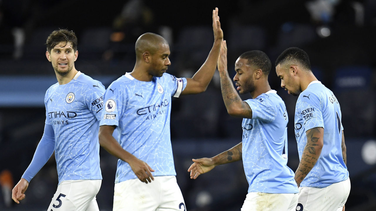 MANCHESTER, ENGLAND - JANUARY 17: Raheem Sterling of Manchester City celebrates with team mates (L - R) John Stones, Fernandinho and Gabriel Jesus after scoring their side's fourth goal during the Premier League match between Manchester City and Crystal Palace at Etihad Stadium on January 17, 2021 in Manchester, England. Sporting stadiums around England remain under strict restrictions due to the Coronavirus Pandemic as Government social distancing laws prohibit fans inside venues resulting in games being played behind closed doors.
