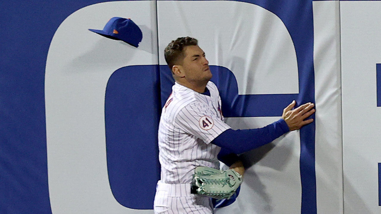 NEW YORK, NEW YORK - MAY 11: Albert Almora Jr. #4 of the New York Mets catches a hit by Austin Hays #21 of the Baltimore Orioles in the eighth inning but drops it after he collides with the wall giving Hays a triple at Citi Field on May 11, 2021 in the Flushing neighborhood of the Queens borough of New York City.