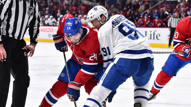 MONTREAL, QC - FEBRUARY 09: Phillip Danault #24 of the Montreal Canadiens and John Tavares #91 of the Toronto Maple Leafs face-off against each other during the NHL game at the Bell Centre on February 9, 2019 in Montreal, Quebec, Canada. The Toronto Maple Leafs defeated the Montreal Canadiens 4-3 in overtime.