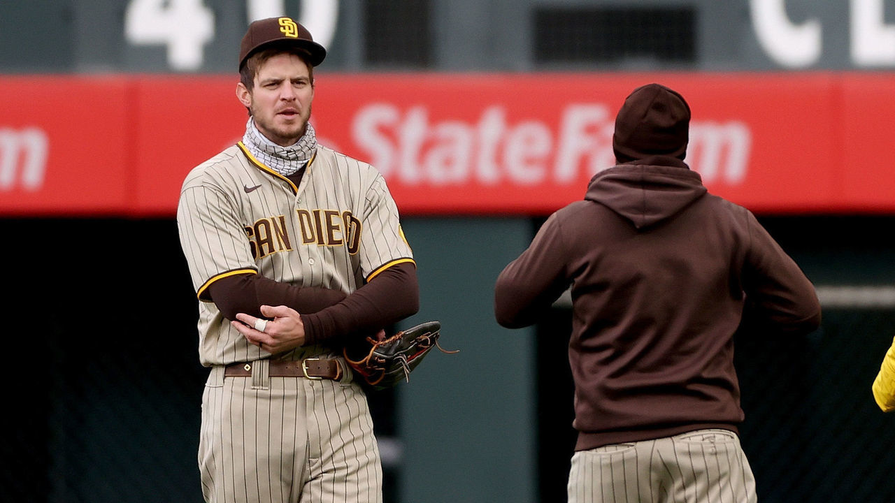 DENVER, COLORADO - MAY 11: Will Myers #5 of the San Diego Padres is attended to in the outfield after going to the wall for a Garrett Hampson of the Colorado Rockies fly ball in the first inning at Coors Field on May 11, 2021 in Denver, Colorado.