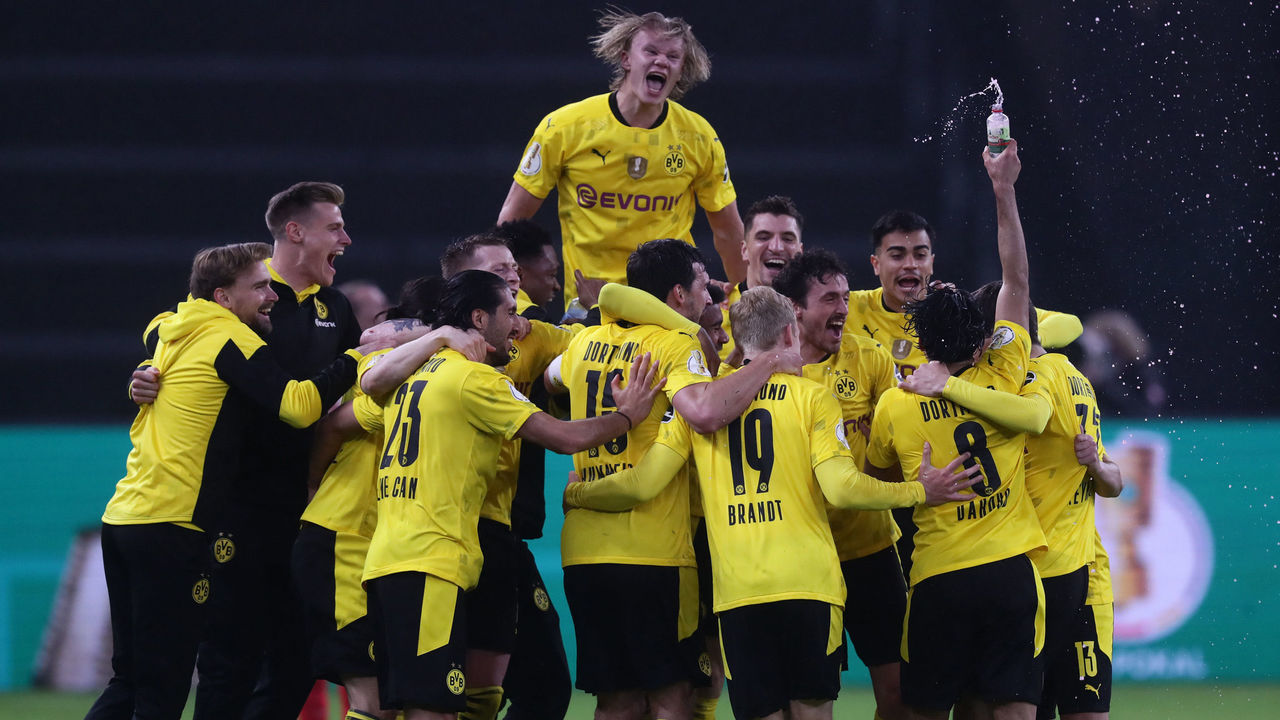 BERLIN, GERMANY - MAY 13: Erling Haaland (top) and teammates of Borussia Dortmund celebrate victory after the final whistle of the DFB Cup final match between RB Leipzig and Borussia Dortmund at Olympic Stadium on May 13, 2021 in Berlin, Germany. Sporting stadiums around Germany remain under strict restrictions due to the Coronavirus Pandemic as Government social distancing laws prohibit fans inside venues resulting in games being played behind closed doors.