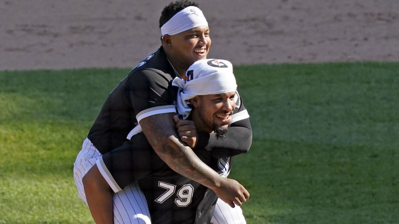 CHICAGO, ILLINOIS - MAY 13: Yermin Mercedes #73 of the Chicago White Sox rides on the back of Jose Abreu #79 at the end of their team's win over the Minnesota Twins at Guaranteed Rate Field on May 13, 2021 in Chicago, Illinois. The White Sox defeated the Twins 4-2.