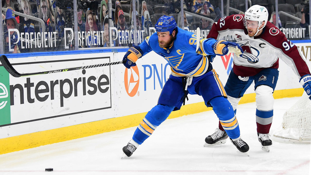 ST. LOUIS, MO - APRIL 24: St. Louis Blues center Ryan O'Reilly (90) and Colorado Avalanche left wing Gabriel Landeskog (92) go after a loose puck during a NHL game between the Colorado Avalanche and the St. Louis Blues on April 24, 2021, at Enterprise Center, St. Louis, Mo. ,