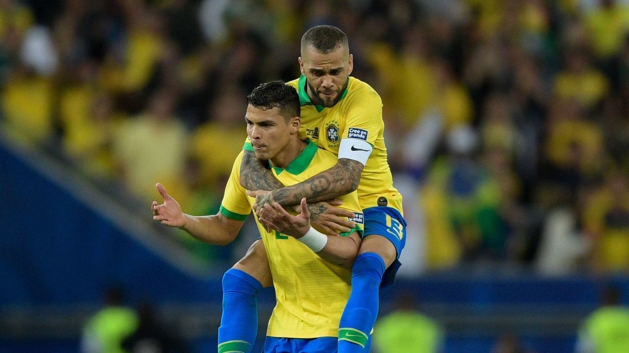 Brazil's Dani Alves (top) and Thiago Silva celebrate after teammate Gabriel Jesus scored the team's second goal against Peru during the Copa America football tournament final match at Maracana Stadium in Rio de Janeiro, Brazil, on July 7, 2019.