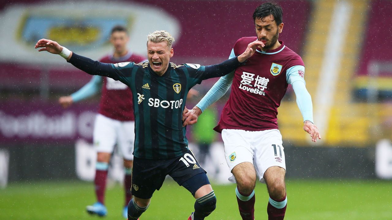 BURNLEY, ENGLAND - MAY 15: Ezgjan Alioski of Leeds United and Dwight McNeil of Burnley battle for the ball during the Premier League match between Burnley and Leeds United at Turf Moor on May 15, 2021 in Burnley, England. Sporting stadiums around the UK remain under strict restrictions due to the Coronavirus Pandemic as Government social distancing laws prohibit fans inside venues resulting in games being played behind closed doors.