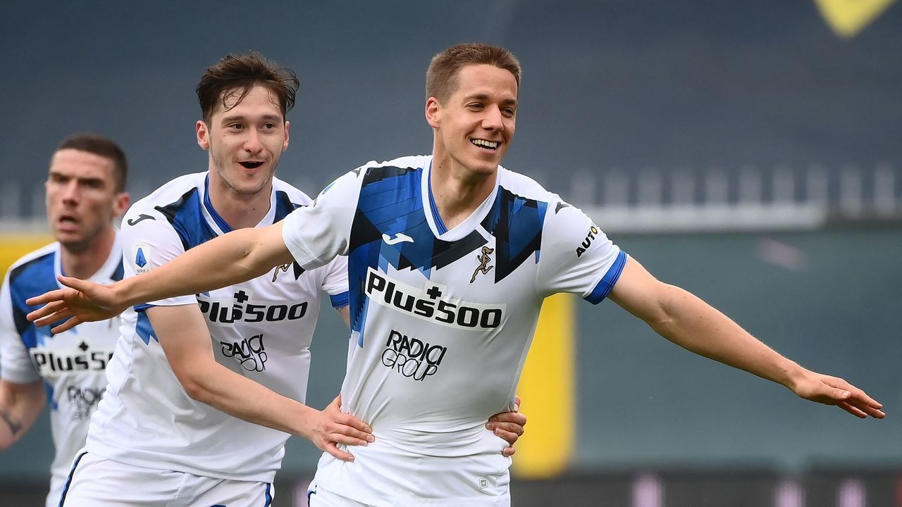 Atalanta's Croatian midfielder Mario Pasalic (R) celebrates with Atalanta's Russian midfielder Aleksey Miranchuk after scoring during the Italian Serie A football match Genoa vs Atalanta Bergamo on May 15, 2021 at the Luigi-Ferraris stadium in Genoa.