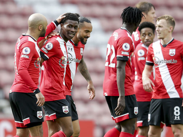 SOUTHAMPTON, ENGLAND - MAY 15: Nathan Redmond of Southampton congratulates team-mate Nathan Tella after he sets up Theo Walcott to score Saints third goal during the Premier League match between Southampton and Fulham at St Mary's Stadium on May 15, 2021 in Southampton, England.