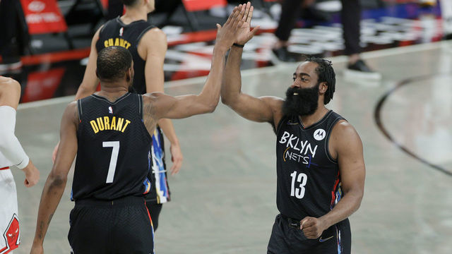 NEW YORK, NEW YORK - MAY 15: James Harden #13 high-fives Kevin Durant #7 of the Brooklyn Nets during the second half against the Chicago Bulls at Barclays Center on May 15, 2021 in the Brooklyn borough of New York City. The Nets won 105-91.