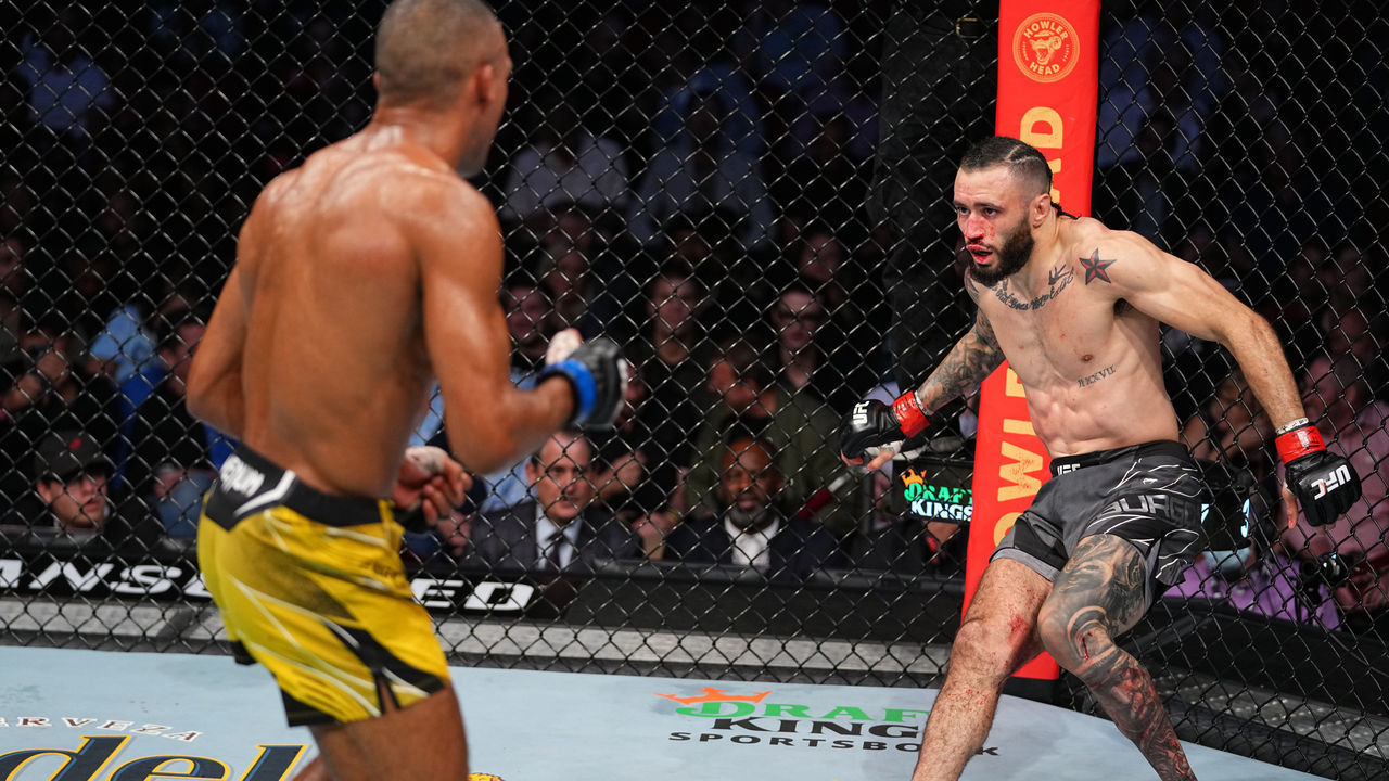 HOUSTON, TEXAS - MAY 15: (R-L) Shane Burgos falls back after taking punches from Edson Barboza of Brazil in their featherweight bout during the UFC 262 event at Toyota Center on May 15, 2021 in Houston, Texas.
