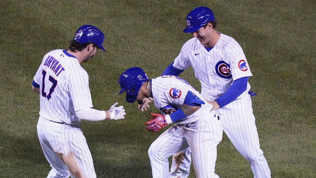 CHICAGO, ILLINOIS - SEPTEMBER 16: Javier Baez #9 of the Chicago Cubs celebrates with Anthony Rizzo #44 and Kris Bryant #17 following his RBI during the tenth inning of a game against the Cleveland Indians at Wrigley Field on September 16, 2020 in Chicago, Illinois.