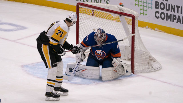 UNIONDALE, NY - FEBRUARY 11: New York Islanders Goalie Semyon Varlamov (40) makes a save on Pittsburgh Penguins Center Evgeni Malkin (71) shot on goal during the overtime period of the National Hockey League game between the Pittsburgh Penguins and the New York Islanders on February 11, 2021, at the Nassau Veterans Memorial Coliseum in Uniondale, NY.