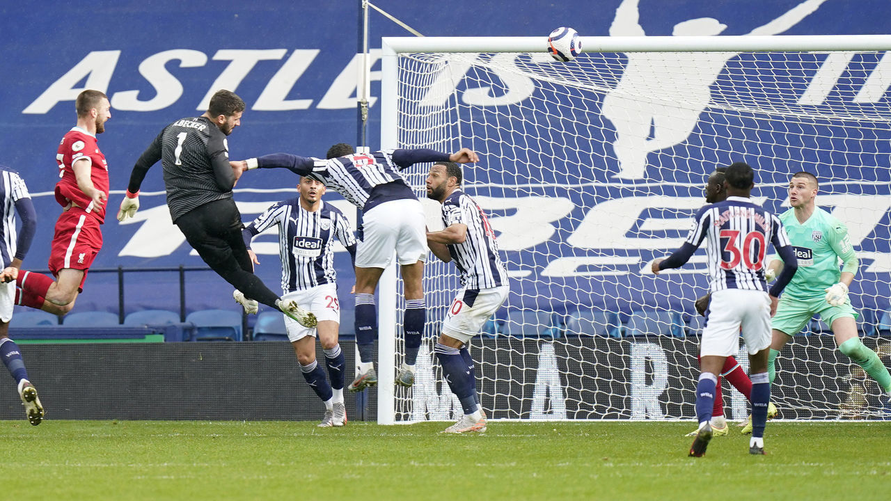 WEST BROMWICH, ENGLAND - MAY 16: Alisson of Liverpool scores their side's second goal past Sam Johnstone of West Bromwich Albion during the Premier League match between West Bromwich Albion and Liverpool at The Hawthorns on May 16, 2021 in West Bromwich, England. Sporting stadiums around the UK remain under strict restrictions due to the Coronavirus Pandemic as Government social distancing laws prohibit fans inside venues resulting in games being played behind closed doors.