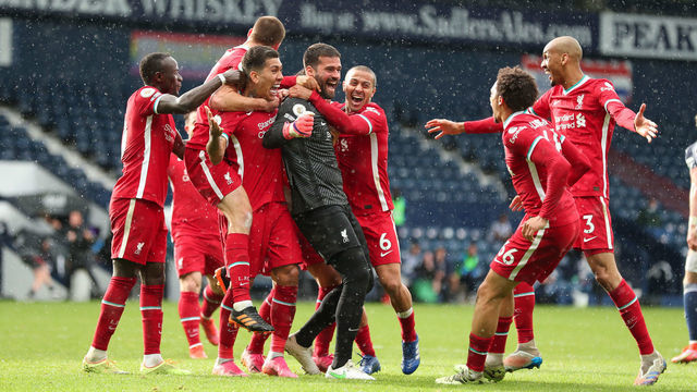 WEST BROMWICH, ENGLAND - MAY 16: Goalkeeper Alisson Becker of Liverpool celebrates after scoring a goal to make it 1-2 during the Premier League match between West Bromwich Albion and Liverpool at The Hawthorns on May 16, 2021 in West Bromwich, United Kingdom.