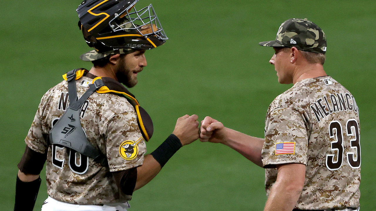 SAN DIEGO, CALIFORNIA - MAY 16: Austin Nola #26 and Mark Melancon #33 of the San Diego Padres celebrate defeating the St. Louis Cardinals 5-3 in a game at PETCO Park on May 16, 2021 in San Diego, California.