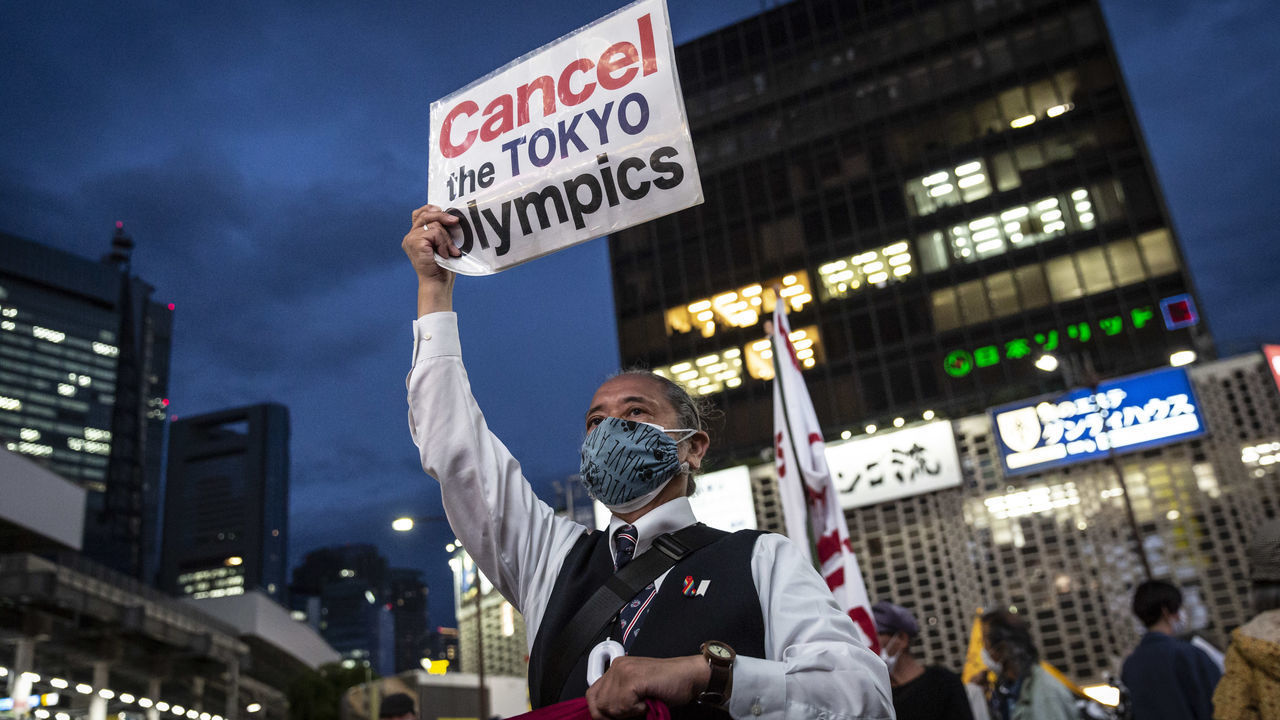 TOKYO, JAPAN - MAY 17: A protester holds a placard during a protest against the Tokyo Olympics on May 17, 2021 in Tokyo, Japan. With less than 3 months remaining until the Tokyo Olympics, a recent survey has indicated that around 60 percent of Japanese people do not want the Games to go ahead. Although it marks a drop in an earlier survey in which around 80 percent of people believed the Olympics and Paralympics should be cancelled or rescheduled, concern continues to linger in Japan over the feasibility of hosting such a huge event during the ongoing Covid-19 pandemic.