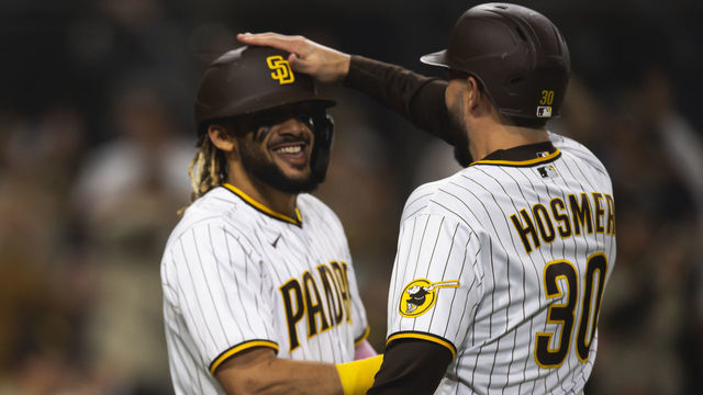 SAN DIEGO, CA - MAY 1: Eric Hosmer #30 and Fernando Tatis Jr. #23 of the San Diego Padres celebrate after scoring in the eighth inning against the San Francisco Giants on May 1, 2021 at Petco Park in San Diego, California.