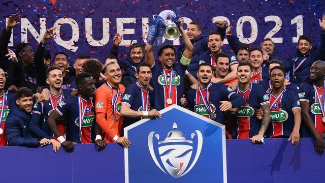 Paris Saint-Germain's Brazilian defender Marquinhos (C) celebrate with the trophy after winning the French Cup final football match between Paris Saint-Germain and Monaco at the Stade de France stadium, in Saint-Denis, on the outskirts of Paris, on May 19, 2021.
