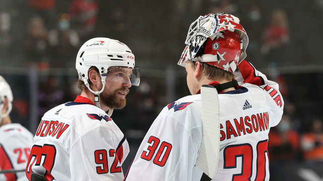 PHILADELPHIA, PA - APRIL 17: Ilya Samsonov #30 and Evgeny Kuznetsov #92 of the Washington Capitals gather during a timeout against the Philadelphia Flyers at the Wells Fargo Center on April 17, 2021 in Philadelphia, Pennsylvania.