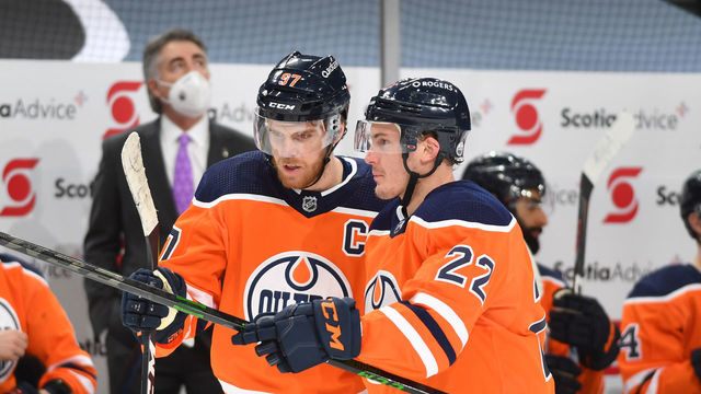EDMONTON, AB - MARCH 12: Connor McDavid #97 and Tyson Barrie #22 of the Edmonton Oilers discuss the play during the game against the Ottawa Senators on March 12, 2021 at Rogers Place in Edmonton, Alberta, Canada.