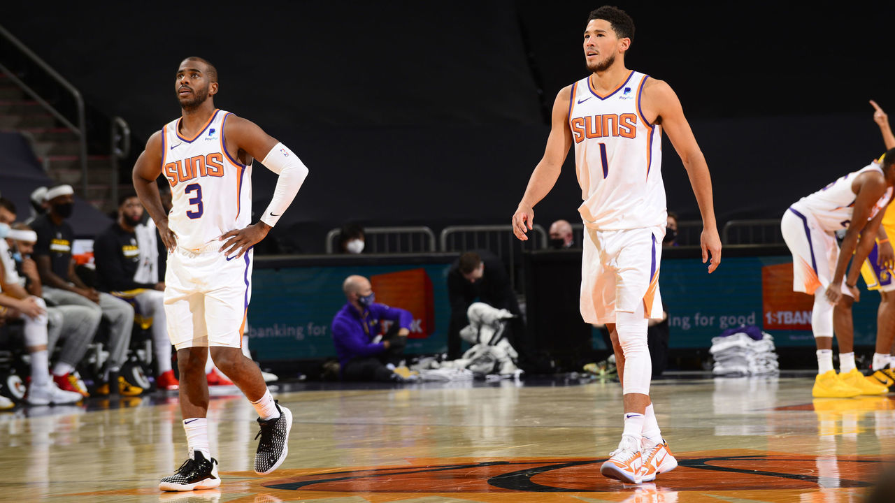 PHOENIX, AZ - DECEMBER 16: Chris Paul #3 and Devin Booker #1 of Phoenix Suns looks on against the Los Angeles Lakers on December 16, 2020 at the Talking Stick Resort Arena in Phoenix, Arizona. Mandatory Copyright Notice: Copyright 2020 NBAE