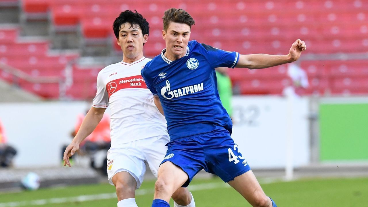 Stuttgart's Japanese midfielder Wataru Endo (L) and Schalke's US forward Matthew Hoppe cie for the ball during the German first division Bundesliga football match between VfB Stuttgart and Schalke 04 in Stuttgart, southwestern Germany, on February 27, 2021.