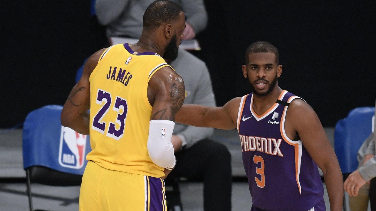 LOS ANGELES, CALIFORNIA - MARCH 02: Chris Paul #3 of the Phoenix Suns and LeBron James #23 of the Los Angeles Lakers shake hands after a 114-104 Suns win at Staples Center on March 02, 2021 in Los Angeles, California. NOTE TO USER: User expressly acknowledges and agrees that, by downloading and/or using this Photograph, user is consenting to the terms and conditions of the Getty Images License Agreement. Mandatory Copyright Notice: Copyright 2021 NBAE.