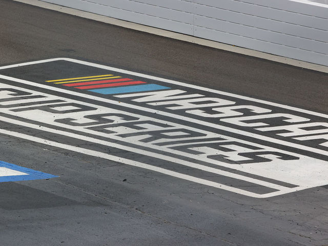 DOVER, DE - MAY 16: A general view of the Nascar Cup Series logo painted on the track during the NASCAR Cup Series - Drydene 400 on May 16, 2021 at Dover International Speedway in Dover, DE.