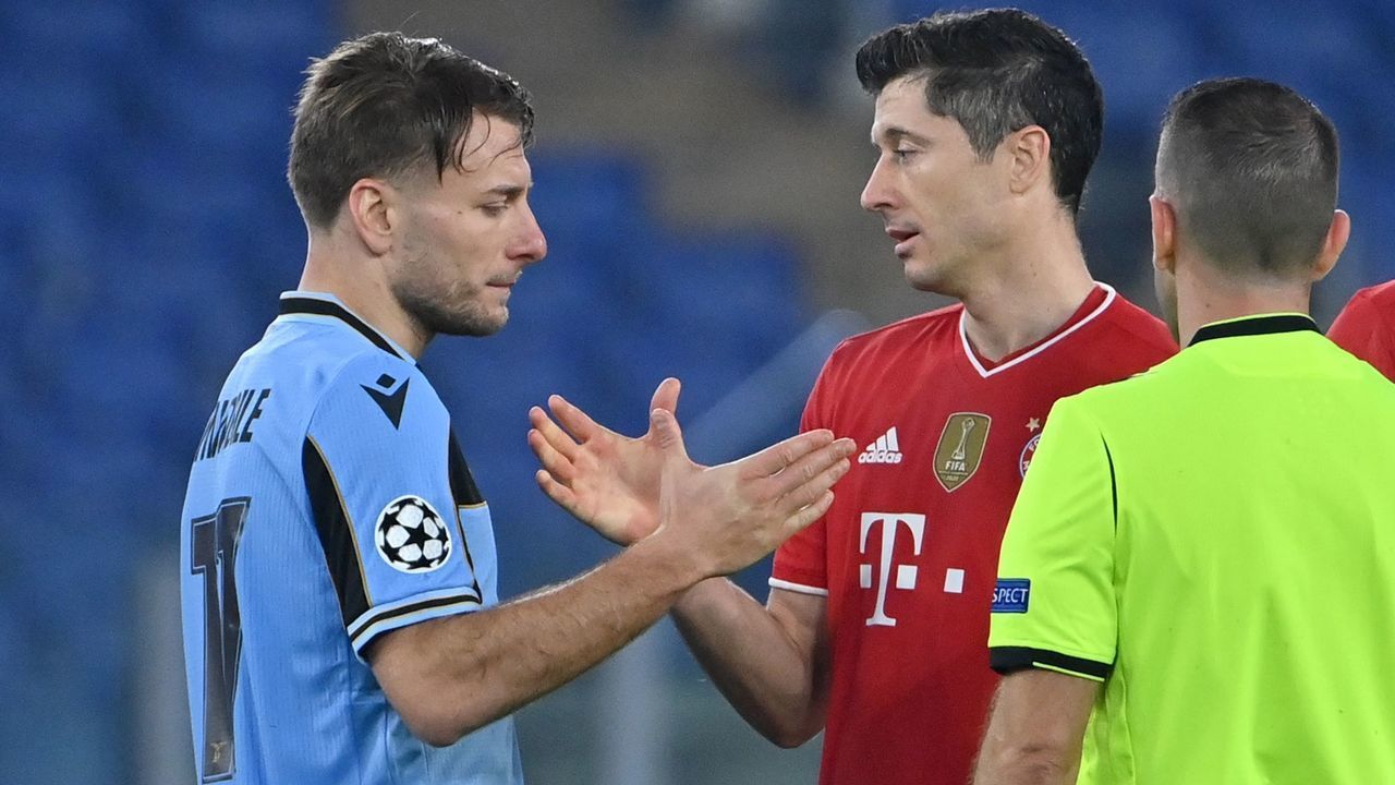 Lazio's Italian forward Ciro Immobile (L) and Bayern Munich's Polish forward Robert Lewandowski tap hands at the end of the UEFA Champions League round of 16 first leg football match Lazio Rome vs Bayern Munich on February 23, 2021 at the Olympic stadium in Rome.