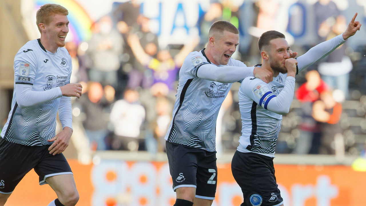 SWANSEA, WALES - MAY 22: Matt Grimes of Swansea City (R) celebrates his goal with Jay Fulton (L) and Jake Bidwell (2nd L) and Conor Hourihane during the Sky Bet Championship Play-off Semi Final 2nd Leg match between Swansea City and Barnsley at the Liberty Stadium on May 22, 2021 in Swansea, Wales.
