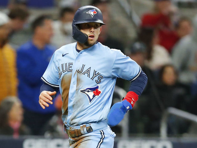 ATLANTA, GA - MAY 12: Cavan Biggio #8 of the Toronto Blue Jays scores on a Marcus Semien double in the sixth inning against the Atlanta Braves at Truist Park on May 12, 2021 in Atlanta, Georgia.