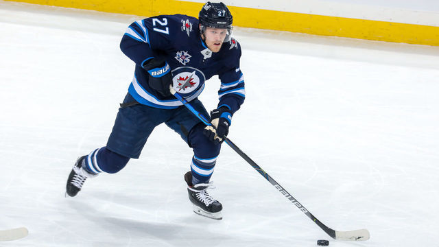 WINNIPEG, MB - APRIL 24: Nikolaj Ehlers #27 of the Winnipeg Jets plays the puck during first period action against the Toronto Maple Leafs at Bell MTS Place on April 24, 2021 in Winnipeg, Manitoba.