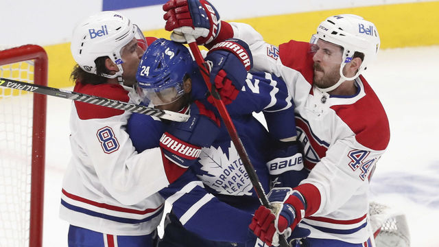 TORONTO, ON - May 22 In third period action, Toronto Maple Leafs right wing Wayne Simmonds (24) gets roughed up by Montreal Canadiens defenseman Ben Chiarot (8) and Montreal Canadiens defenseman Joel Edmundson (44) The Toronto Maple Leafs beat the Montreal Canadiens 5-1 at the Scotiabank Arena in game 2 of the first round of NHL hockey playoffs. Montreal went into the game after a victory that saw the Leafs lose their captain John Tavares to injury. May 22 2021 (Richard Lautens/Toronto Star via Getty Images)