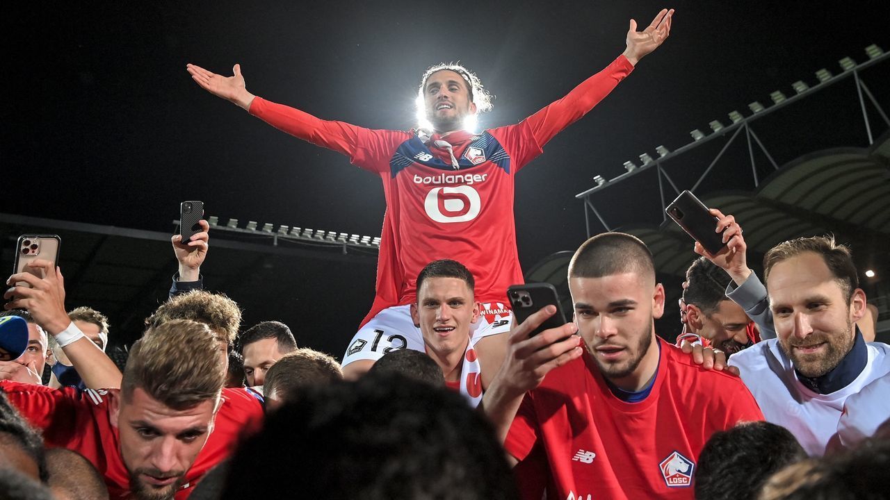 Lille's players celebrate after winning the French L1 football match between Angers SCO and Lille OSC at The Raymond-Kopa Stadium in Angers, north-western France on May 23, 2021.
