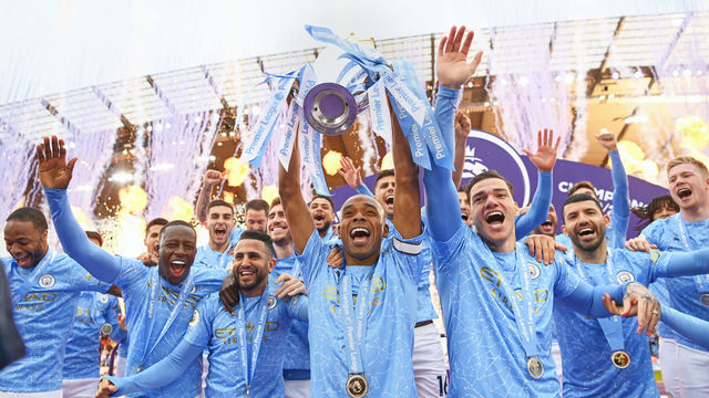 MANCHESTER, ENGLAND - MAY 23: Fernandinho of Manchester City lifts the Premier League Trophy with team mates Benjamin Mendy, Riyad Mahrez, Ederson and Sergio Aguero as Manchester City are presented with the Trophy as they win the league following the Premier League match between Manchester City and Everton at Etihad Stadium on May 23, 2021 in Manchester, England. A limited number of fans will be allowed into Premier League stadiums as Coronavirus restrictions begin to ease in the UK.